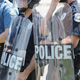 Police officers equipped in riot gear line up during a protest of the shooting death of 18-year-old Michael Brown outside Ferguson Police Department headquarters Aug. 11, 2014, in Ferguson, Mo.
Michael B. Thomas/Getty Images
